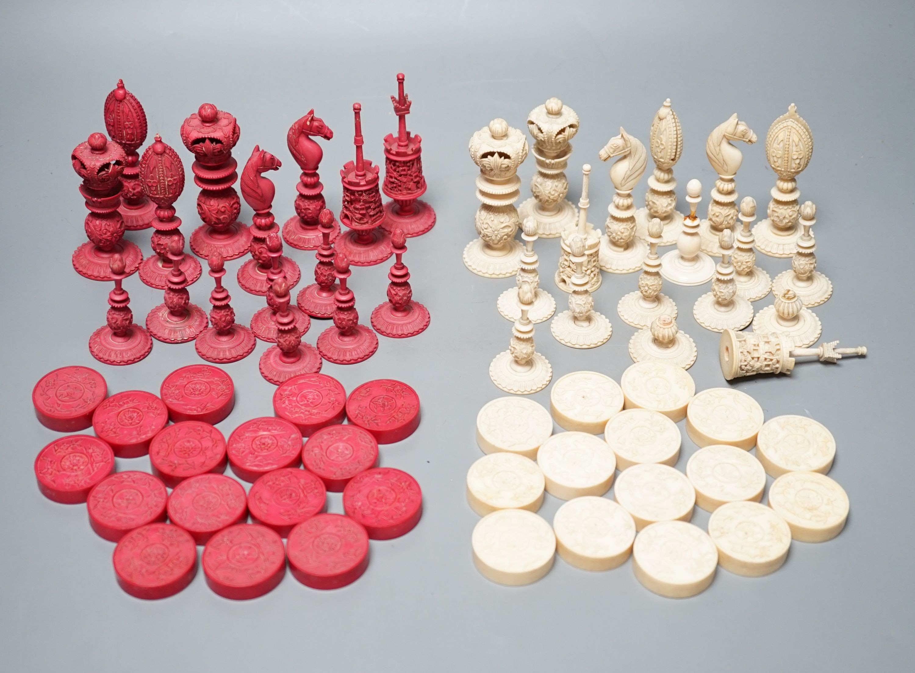 A 19th century Chinese export Burmese pattern carved and stained ivory chess set, one white pawn associated